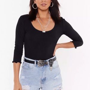 Scoop neck body suit with 3/4 length sleeves and lettuce hem trim